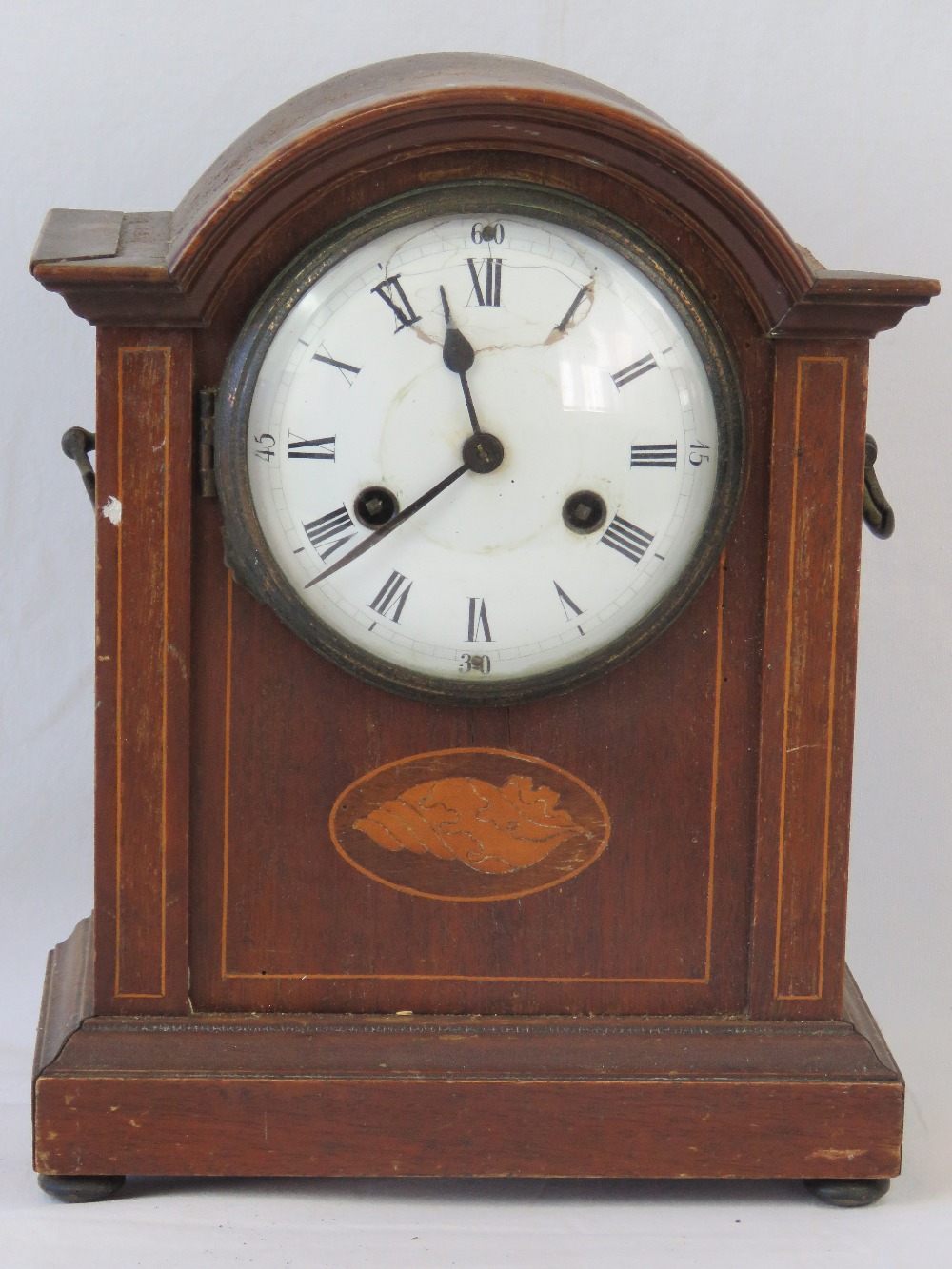 An Edwardian mahogany eight day striking table clock, enamelled dial with Roman numerals,