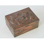 A Chinese embossed metal covered box having three-toed dragon with ball to lid and turbulent seas