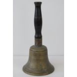 A 19thC heavy brass hand bell with turned ebony handle, 30cm.