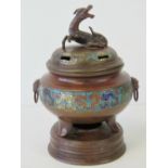 A fine bronze Oriental lidded censer having a band of cloisonné decoration and raised over three