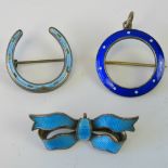 Three guilloche enamel brooches; a 930 Sterling silver horseshoe with pale blue enamel,