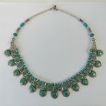 A Native American style turquoise and white metal beaded necklace, approx 50cm in length.