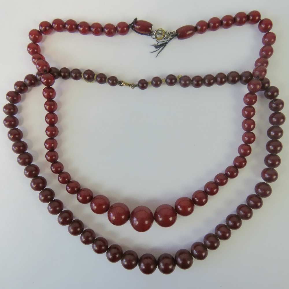 Two vintage cherry amber type graduating bead necklaces.