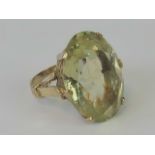 A citrine cocktail ring, oval faceted stone approx 2.5 x 1.8cm, claw set in yellow metal, size M-N.