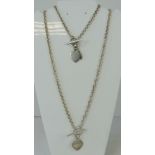 A silver necklace and bracelet set, each having T-bar clasp with heart tag, each stamped 925,