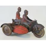 A vintage Tip & Cotin plate motor bike and sidecar having clockwork movement, 26cm in length.