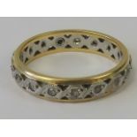 An 18ct gold and platinum eternity ring, central platinum band set with white stones,