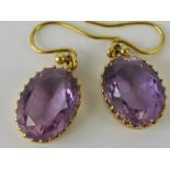 A pair of Amethyst earrings, each stone being oval cut and approx 4.