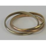 An 18ct gold trio of interlinked rings being yellow, rose and white gold, stamped 18ct, size Z, 5g.