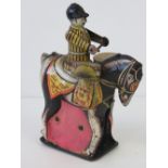 A vintage tin plate British made mounted drummer toy, 14cm high.
