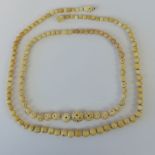 A vintage ivory bead necklace with screw fitting together with an Oriental type bone bead necklace