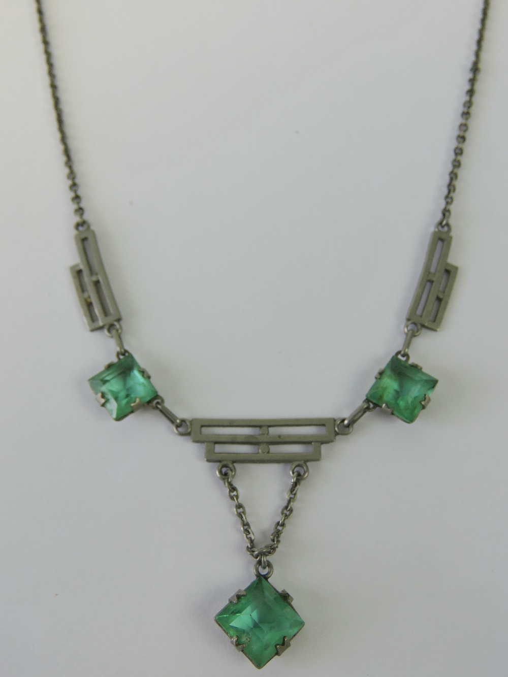 A delightful Art Deco necklace having three geometric stepped panels separated by two square cut