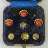 A set of three vintage buttons having coral coloured glass cabachon on gilt mount.