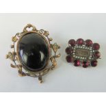 A delightful Edwardian rose metal brooch having central black cabachon,