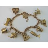 A 9ct gold charm bracelet with heart padlock clasp and nine charms, 37.22g.