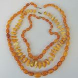 Three vintage Baltic egg yolk amber type bead necklaces. Two worked and one unworked. Re-strung.