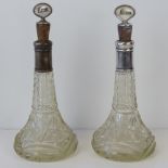 A delightful pair of HM silver collared cut glass rum decanters complete with silver plated and