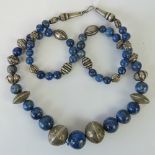 A long single strand lapis lazuli and white metal bead necklace, need re-stringing, 85cm in length.