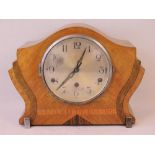 An Art Deco mantle clock having silver dial with Arabic numerals, three train movement,