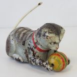 A vintage French made tin plate clockwork kitten with ball of string, moving tail, 9cm in length.