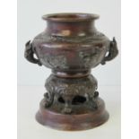 A 19th century Oriental bronzed brass censer on integral six legged stand over circular base,