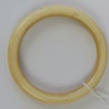 A late 19th / early 20th century carved ivory bangle, 8.8cm outside dia, 7.1cm inside dia.