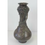 A 19th century bronzed brass Oriental waisted vase decorated with foliage upon, standing 29.