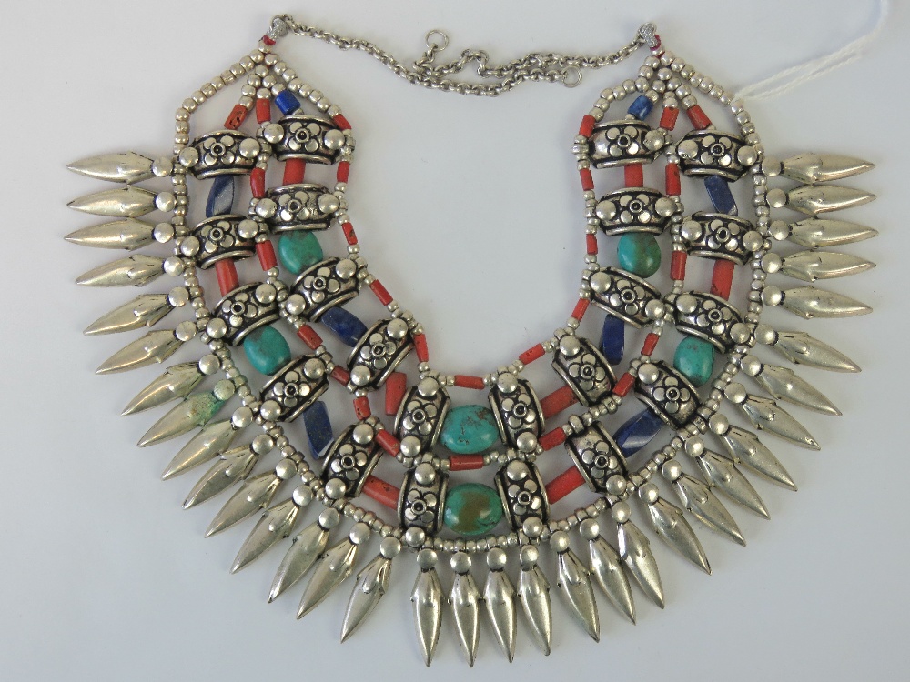 A Native American style necklace having turquoise, lapis lazuli coral and white metal beads,