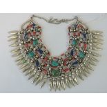 A Native American style necklace having turquoise, lapis lazuli coral and white metal beads,