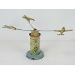 A vintage tin plate aircraft carousel, standing 15cm high, two aircraft propellers deficient.