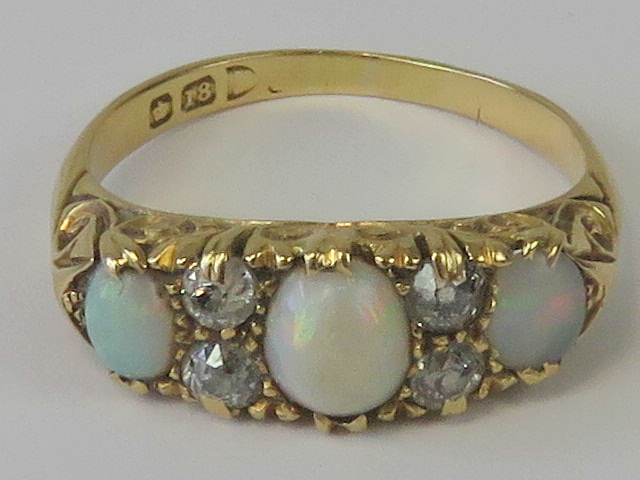 An 18ct gold opal and diamond ring,