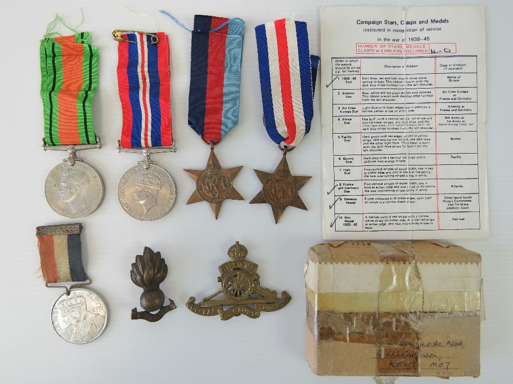 A collection of WWII medals and badges i