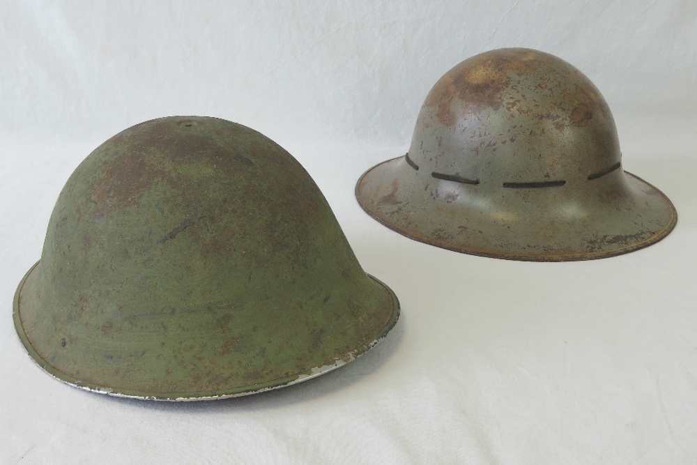 Two original WWI British helmets, one wi