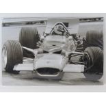 A monochrome print of Graham Hill in his