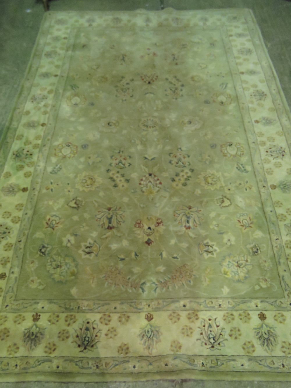 A contemporary green ground woolen rug h