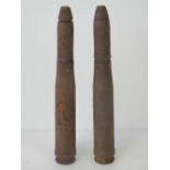 Two inert German rounds in relic condition, each measuring 20.5cm in length.