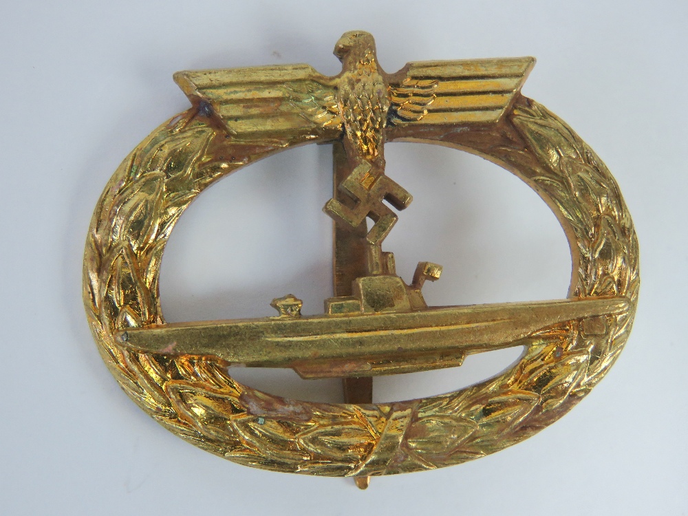 A WWII German Kriegsmarine U Boat badge in gold colour, marked Frank & Reif Stuttgart.