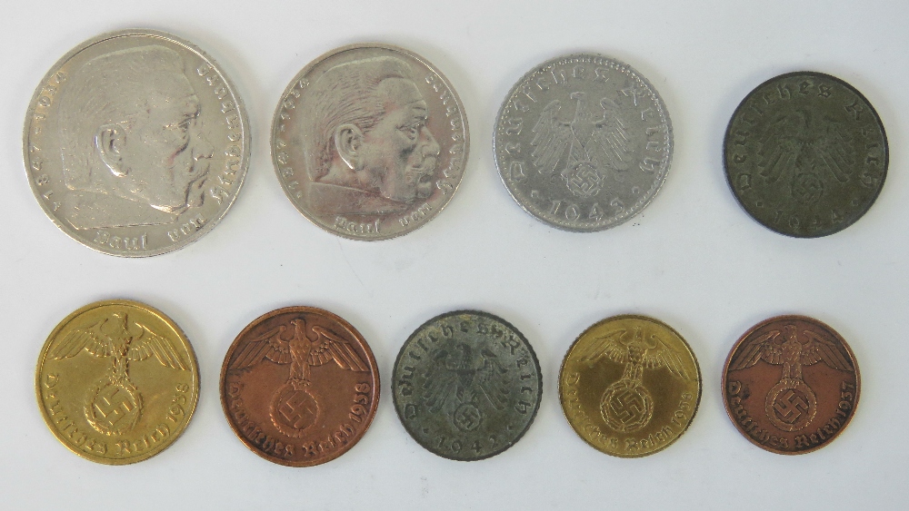 Nine WWII German Reichmark and Fennig coins.
