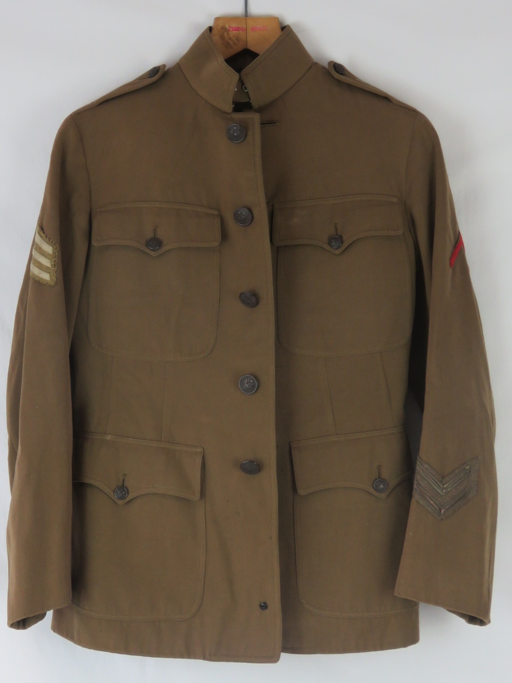 A WWI US military tunic and trousers with buttons and patches.