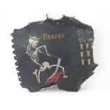 An aeroplane side panel having 'Reaper' skeleton painted upon (later overpainted),