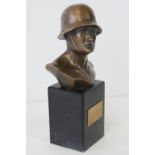 A bronzed brass bust of a soldier upon marble base, uninscribed brass plaque to front,