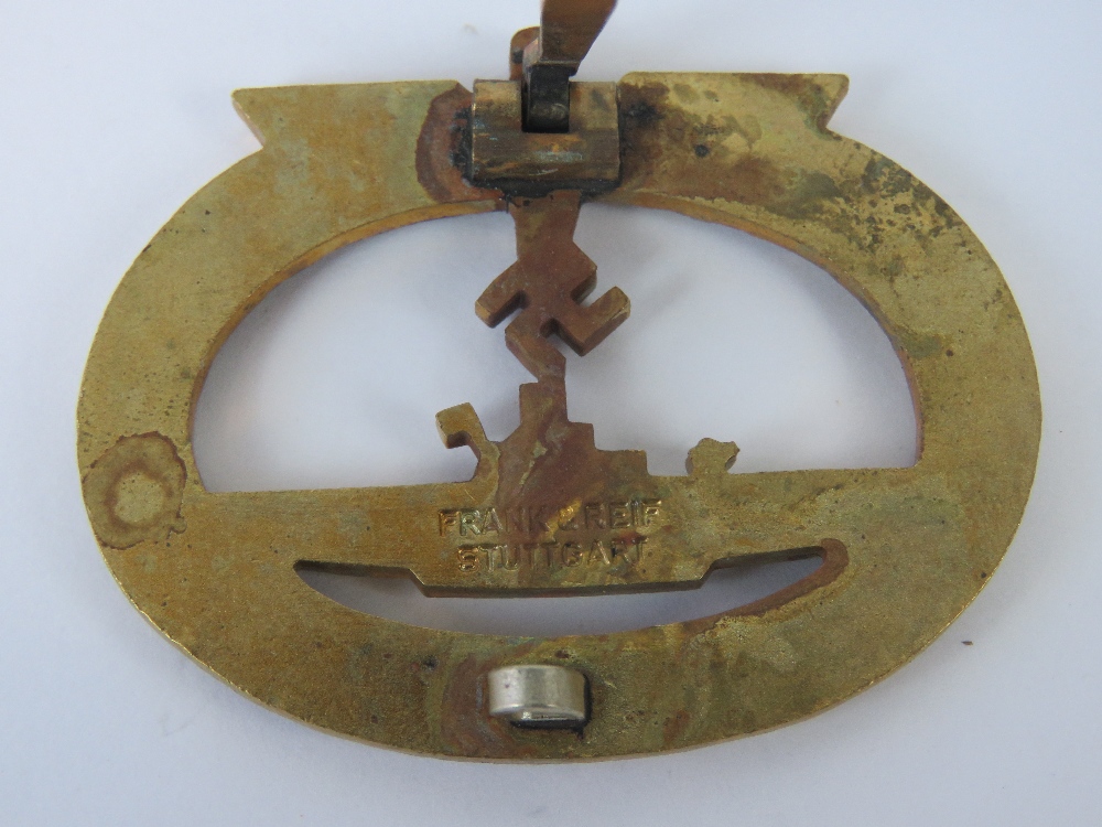 A WWII German Kriegsmarine U Boat badge in gold colour, marked Frank & Reif Stuttgart. - Image 2 of 2