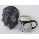 A Berchtasgarden beer jug and a cast metal hitler profile plaque. Two items.