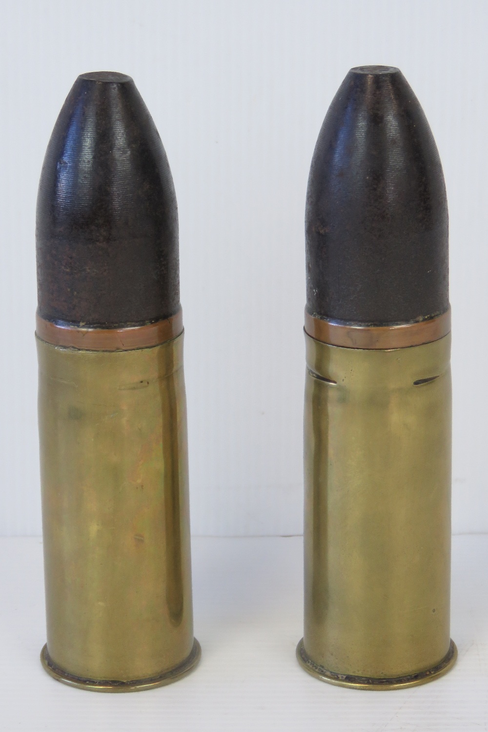 Two WWI ordnance shells, one stamped June 1918 Sp255 119A and the other 1904 116, 16cm high.