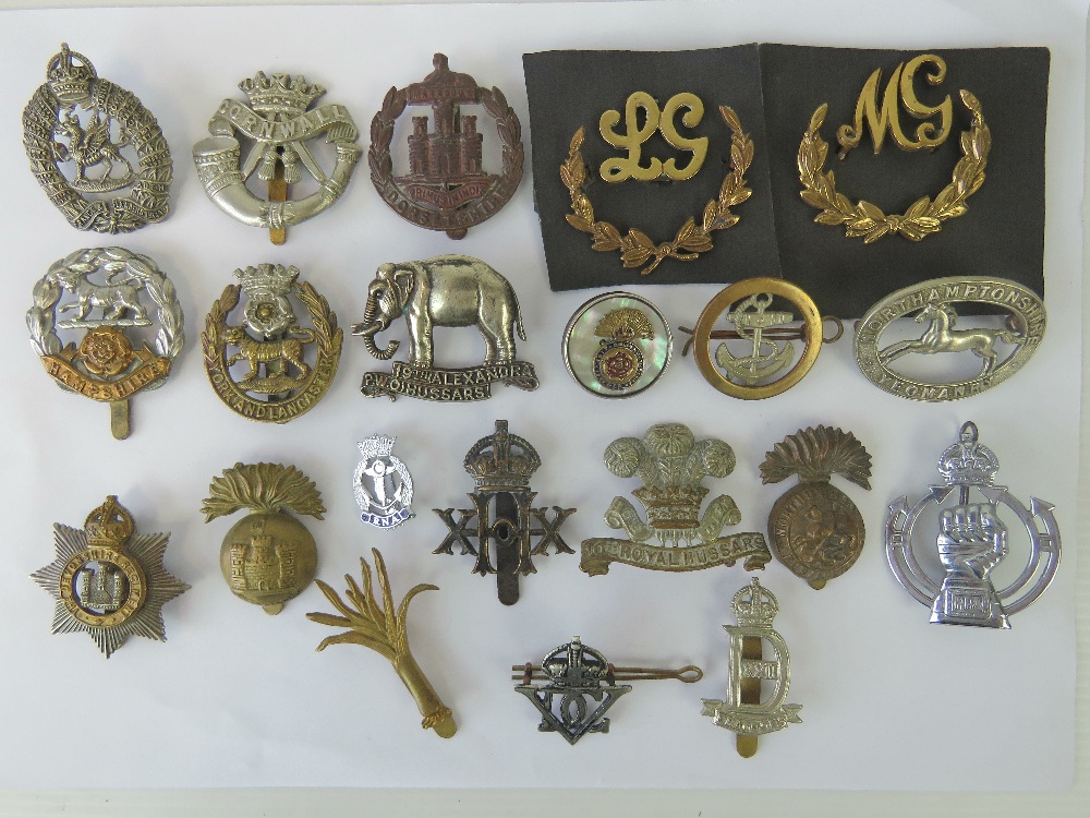 A quantity of assorted cap badges including; 10th Royal Hussars, Cornwall, Northamptonshire,