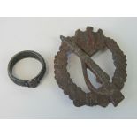 A WWII German Infantry badge, in relic condition, together with a SS honour ring. Two items.