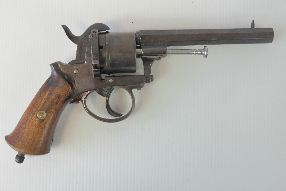 A 19th century Belgian pinfire 9mm calibre revolver having octagonal barrel and wooden handle.