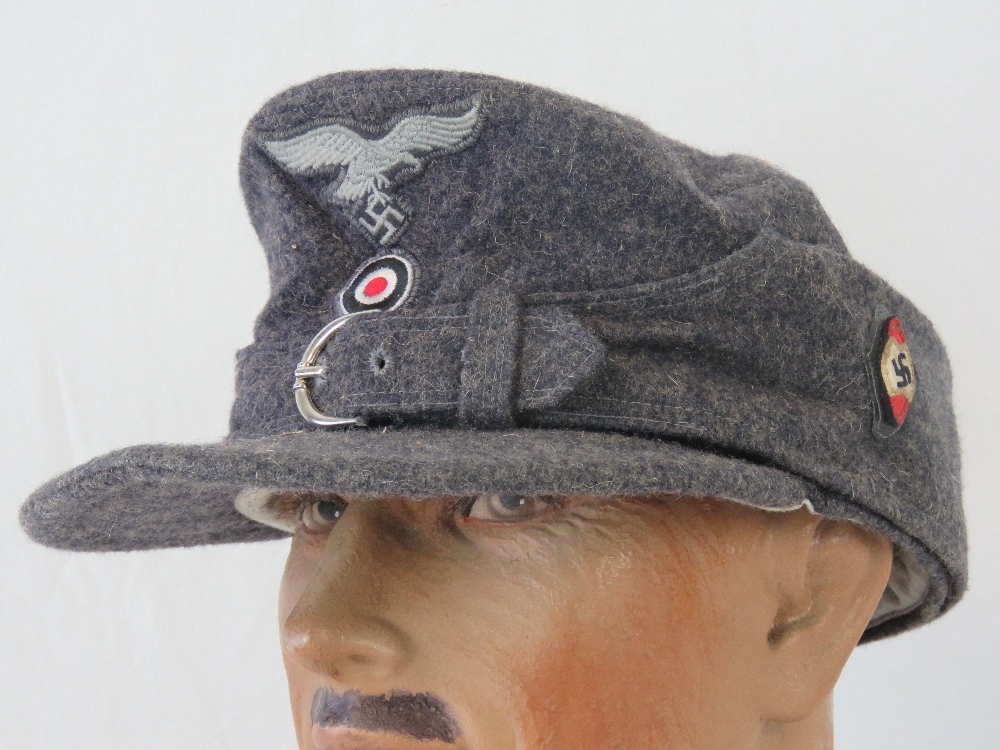 A WWII German Hitler Youth Luftwaffe Regiment ski cap with cloth eagle and badge.