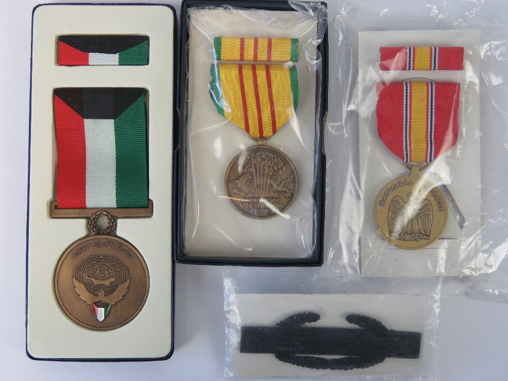 Four assorted military medals in boxes.