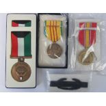 Four assorted military medals in boxes.